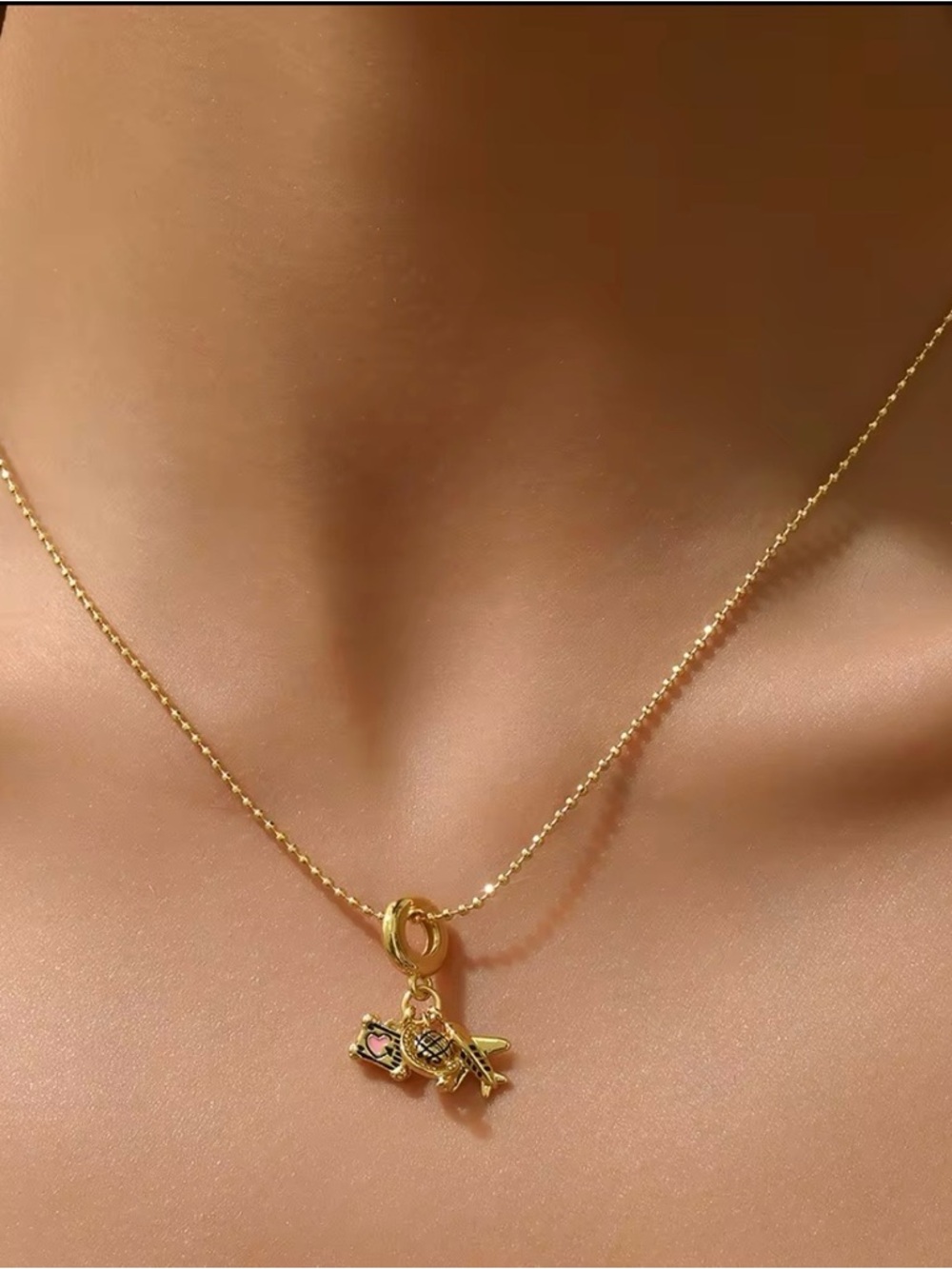 Gold Charm Necklace with Airplane, Globe and Camara Pendants
Stainless Steel